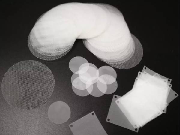 Several pieces of nylon filter disc in round and square shapes.