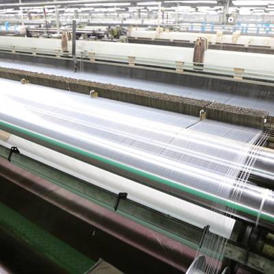 A machine is weaving polyester monofilament mesh.