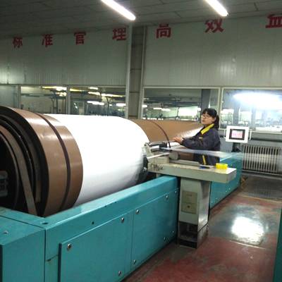 A wrapping machine is wrapping polyester yarn.