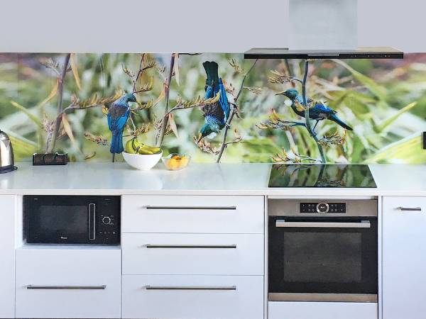 Home appliance glass in the kitchen: oven, microwave oven and wall decoration.